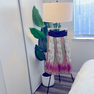 Medium size. Flowy skirt goes below knee.